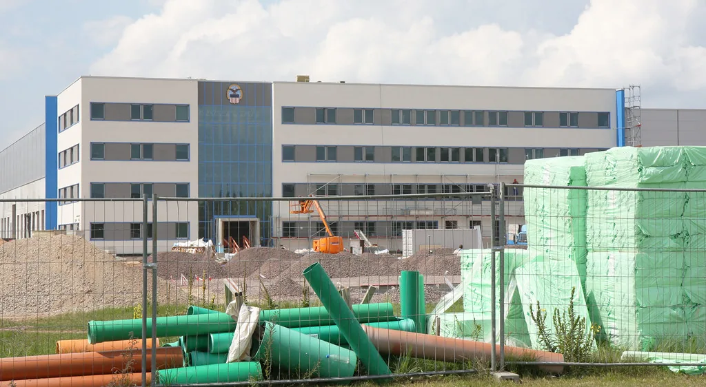 Centro de distribución moderno en construcción con materiales en primer plano